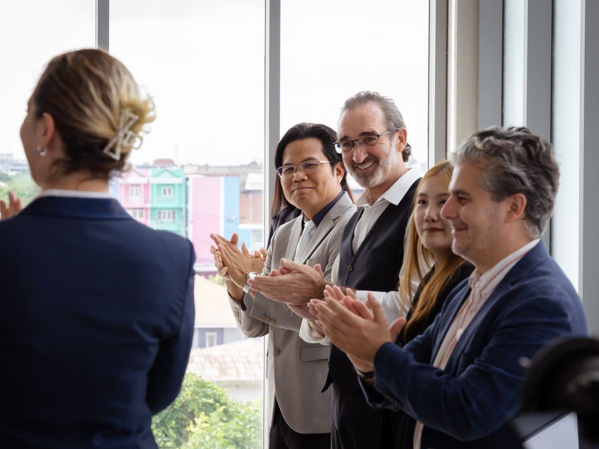 Business people clapping in appreciation, representing recognition