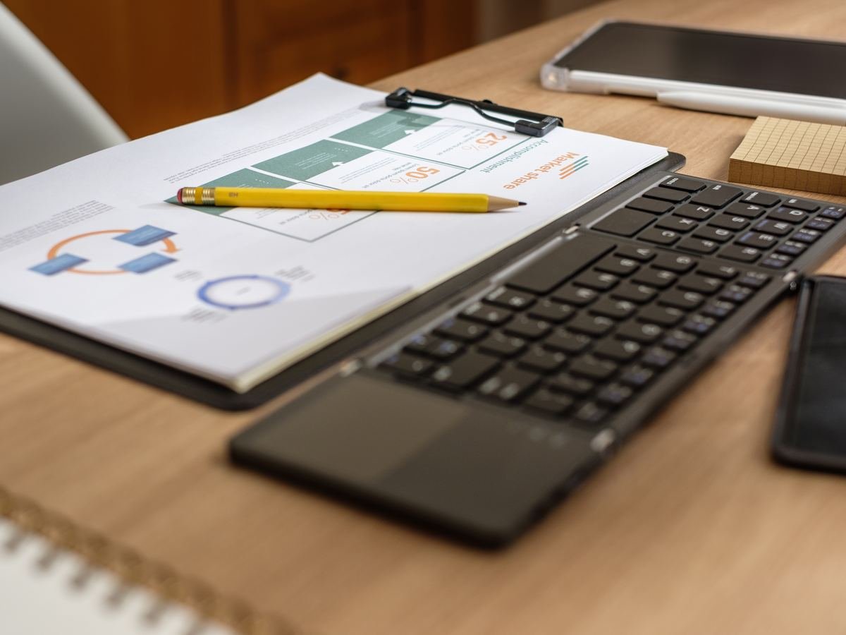 Business graphics and technology on a desk, representing research and publishing